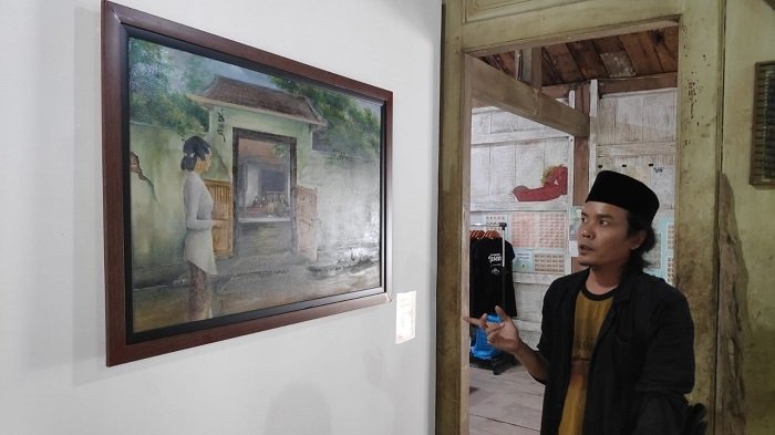 Pameran Cerita Nyah Lasem menjadi Ruang Temu Para Seniman 25 INDAH: Pino seniman Lasem menunjukan hasil karya lukisnya yang dipajang di pameran Cerita Nyah Lasem, kemarin. (R. Teguh Wibowo / Lingkarjateng.id)