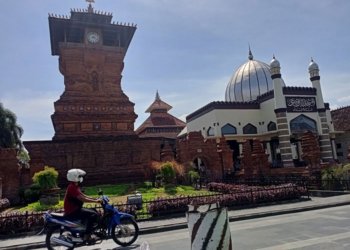 WISATA RELIGI: Seorang pengendara melintas di depan masjid Menara Kudus yang tampak sepi, baru-baru ini. (Alifia Elsa Maulida/Lingkarjateng.id)