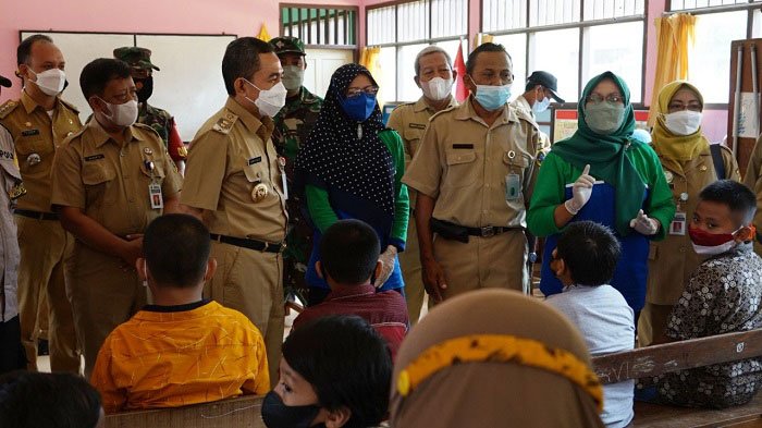 VAKSINASI: Kepala Dinas Kesehatan Kabupaten Pati, dr. Aviani Tritanti Venusia mendampingi Bupati Pati, Haryanto memantau vaksinasi anak di Desa Langenharjo, Kecamatan Margorejo, Senin (3/1). (Istimewa/Lingkarjateng.id)