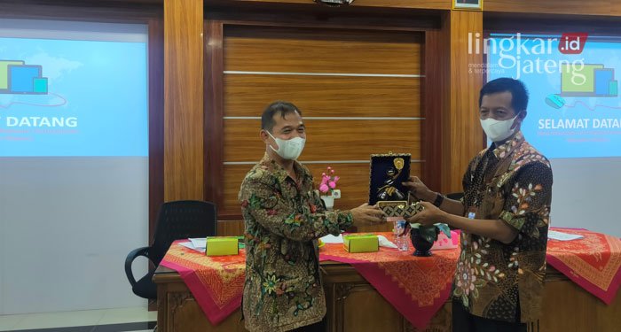 Studi Banding, Dinputaru Demak Terima Kunjungan dari Dinas PUPR Madiun 25 SIMBOLIS: Penyerahan plakat Heru Pitojo (kiri) selaku Kepala PUPR Kabupaten Madiun kepada Kepala Dinputaru Demak, Akhmad Sugiharto (kanan).
