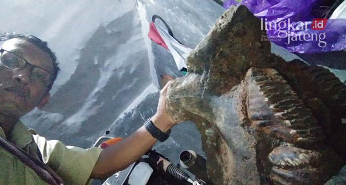 MENEMUKAN: Rohmad menemukan fosil gerigi di Kali Gribik Kelurahan Sadeng, Kecamatan Gunung Pati Semarang. (Adimungkas/Lingkarjateng.id)