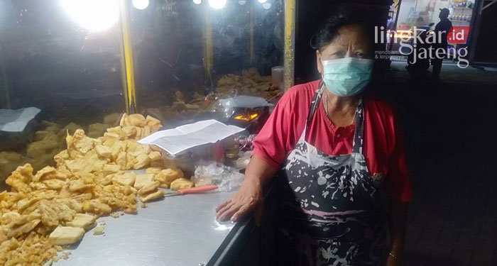 BERJUALAN: Sumini, penjual gorengan asal Semarang mengeluhkan harga minyak goreng yang semakin mahal dan susah ditemukan. (Adimungkas/Lingkarjateng.id)