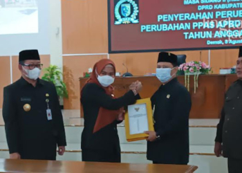 SIMBOLIS: Penyerahan nota kesepakatan dari Ketua DPRD Demak, Sri Fahrudin Bisri Slamet pada Bupati Demak, Eisti’anah dalam Rapat Paripurna ke-18 Masa Sidang II tahun 2022 di Ruang Sidang DPRD Demak pada Senin, 8 Agustus 2022. (Tomi Budianto/Lingkarjateng.id)