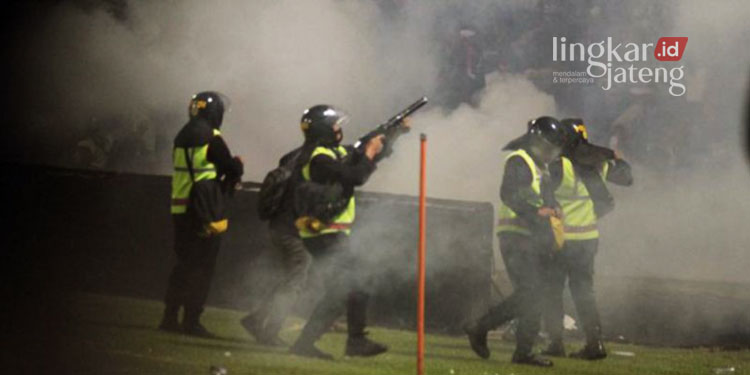 MENEMBAK: Aparat keamanan menembakkan gas air mata untuk menghalau suporter yang masuk ke lapangan usai pertandingan BRI Liga 1 antara Arema melawan Persebaya di Stadion Kanjuruhan, Malang, Jawa Timur pada Sabtu, 1 Oktober 2022 malam. (Istimewa/Lingkarjateng.id)
