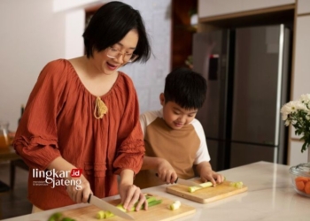ILUSTRASI: Seorang ibu mengajarkan anaknya cara memasak. (Freepik/Lingkarjateng.id)