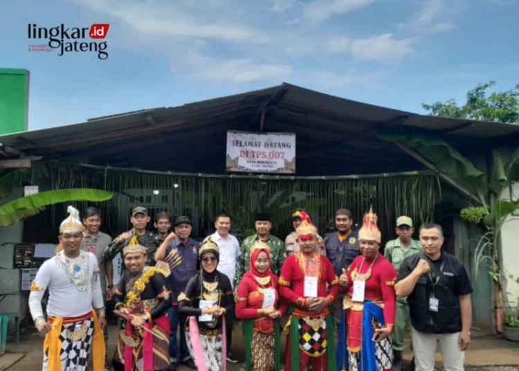 FOTO BERSAMA: Camat Dukuhseti Agus Sunarko, S.STP., MSI. (tengah, berpeci) foto bersama petugas KPPS di Desa Dukuhseti, Kecamatan Dukuhseti, Kabupaten Pati. (Dok. Pemerintah Kecamatan Dukuhseti for Lingkar/Lingkarjateng.id)