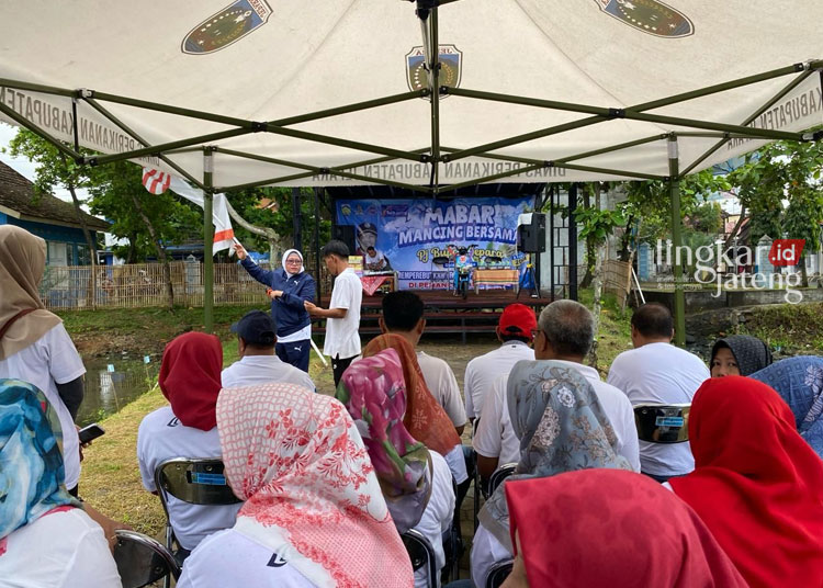 SIMBOLIS: Kepala Diskan Jepara Farikhah Elida saat melepas ikan jackpot sebagai tanda dimulainya turnamen memancing Bupati Cup. (Tomi Budianto/Lingkarjateng.id)