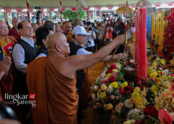 SAKRAL: Sejumlah biksu tengah menghidupkan lilin dan dupa sebelum berdoa di Magelang, tahun lalu. (Rizky Syahrul Al-Fath/Lingkarjateng.id)