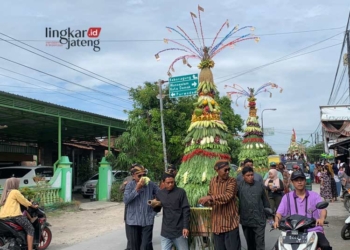 Warga Desa Dempet, Kecamatan Dempet, Kabupaten Demak, sedang mengarak gunungan dalam kirab Apitan pada Selasa, 4 Juni 2024. (M Burhanuddin Aslam/Lingakrjateng.id)
