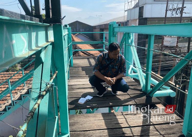 Suhardi, tenaga lapangan salah satu yayasan universitas di Kudus, saat melakukan pengecekan JPO Dersalam, Bae, Kudus, pada Rabu, 28 Agustus 2024. (Mohammad Fahtur Rohman/Lingkarjateng.id)
