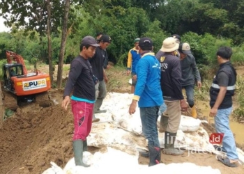 Petugas gabungan saat memperbaiki tanggul kritis di Sungai Godo di Desa Angkatan Lor, Kecamatan Tambakromo, Kabupaten Pati, baru-baru ini. (Setyo Nugroho/Lingkarjateng.id)