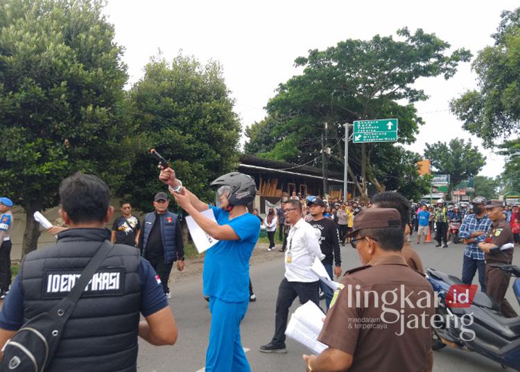 Aipda Robig saat memperagakan adegan dalam rekonstruksi kasus penembakan siswa SMKN 4 Semarang, Gamma Rizkynata Oktafandy (17), pada Senin, 30 Desember 2024. (Rizky Syahrul Al-Fath/Lingkarjateng.id)