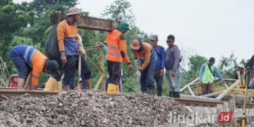 GOTONG ROYONG: Sejumlah pekerja gotong royong memperbaiki jalur kereta api yang terputus akibat banjir di titik Km 32+5/7 antara Stasiun Gubug - Stasiun Karangjati, Kabupaten Grobogan pada Rabu, 22 Januari 2025. (KAI/Lingkar.news)