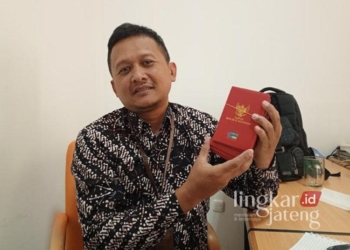 Penyusun Dokumen Haji pada Kantor Kementrian Agama (Kemenag) Kabupaten Pati, Rahardian, tengah memperlihatkan paspor milik para jemaah haji di kantornya pada Kamis, 9 Januari 2025. (Setyo Nugroho/Lingkarjateng.id)