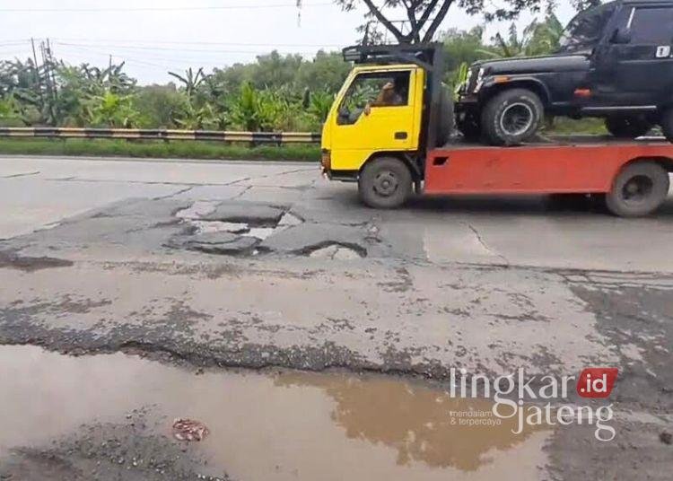 POTRET: Sejumlah kendaraan melintas di Jalan Raya Pantura Pati—Juwana yang berlubang. (Mutia Parasti/Lingkarjateng.id)