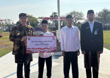 Bupati Jepara, Witiarso Utomo (kiri) menyerahkan surat remisi secara simbolis usai upacara bendera di Alun-alun Jepara II, Minggu, 17 Agustus 2025. (Tomi Budianto/Lingkarjateng.id)