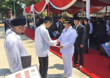 Wali Kota Salatiga Robby Hernawan menyerahkan surat remisi kepada perwakilan WBP Rutan Salatiga saat upacara HUT ke-80 RI di Alun-alun Pancasila, Minggu, 17 Agustus 2025. (Angga Rosa/Lingkarjateng.id)
