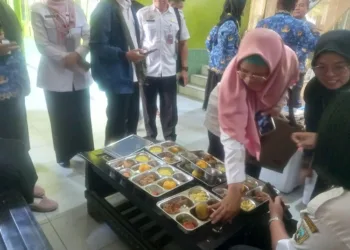 Satuan tugas program makan bergizi gratis SMPN 5 Rembang mengecek menu makan sebelum didistribusikan ke siswa, Rabu, 1 Oktober 2025. (Muhammad Faalih/Lingkarjateng.id)