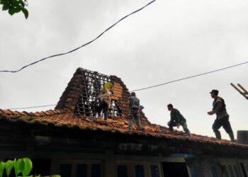 Warga gotong royong memperbaiki atap rumah usai angin puting beliung menerjang di RT 04 RW 02 Desa Gebang, Kecamatan Gabus, Kabupaten Pati pada Jumat, 26 Desember 2025 siang. (Lingkarnews Network)