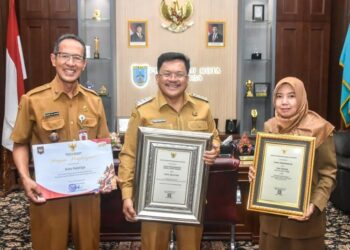 Wali Kota Salatiga Robby Hernawan (tengah) menunjukan piagam penghargaan dari Menkes di ruang kerjanya, Senin, 15 Desember 2025. (Dok. Prokompim Setda Salatiga/Lingkarjateng.id)