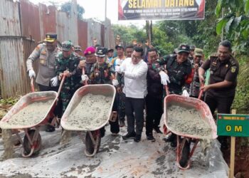 Bupati Kendal, Dyah Kartika Permanasari dan rombongan secara simbolis menuangkan adukan semen sebagai tanda pembangunan jalan rabat beton program TMMD secara resmi dimulai,  Selasa 10 Februari 2026. (Anik Kustiani/Lingkarjateng.id)