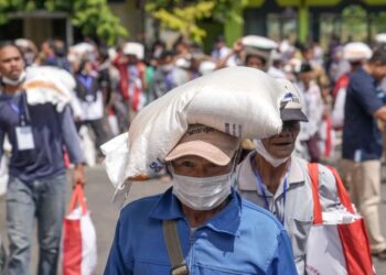 Warga penerima manfaat mendapatkan 10 kilogram beras penyaluran bantuan pangan. (Antara)