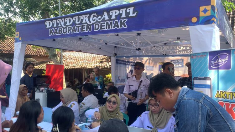 Warga antri memanfaatkan pelayanan adminduk yang dibuka oleh Dindukcapil Demak dalam kegiatan Demang Ngantor Deso, di Balai desa Mangunrejo, Kebonagung. Foto : Burhan Aslam/Lingkar