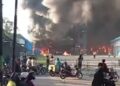 Warga berkerumun di sekitar Pabrik Dua Putra di jalan Pantura Pati-Juwana saat kebakaran terjadi, Sabtu, 6 Juni 2026. (Facebook Pati Kota)