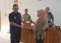 Camat Bojong, Farid Abdul Khakim, menyerahkan surat keputusan (SK) pemberhentian sementara Kepala Desa Randumuktiwaren kepada Sekretaris Desa di Balai Desa Randumuktiwaren, Kecamatan Bojong, Kabupaten Pekalongan, Jumat, 5 Juni 2026. (Fahri Akbar/Lingkarjateng.id)
