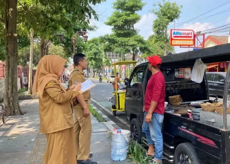 Petugas Dinas Perdagangan Kota Salatiga melayangkan surat peringatan kepada pedagang kaki lima yang berjualan di kawasan larangan, belum lama ini. (Dok Dinas Perdagangan/Lingkarjateng.id)
